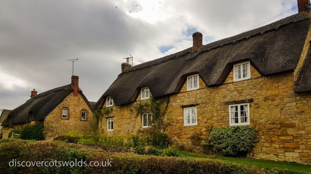 Traditional thatched cottages in the Cotswolds village of Ebrington